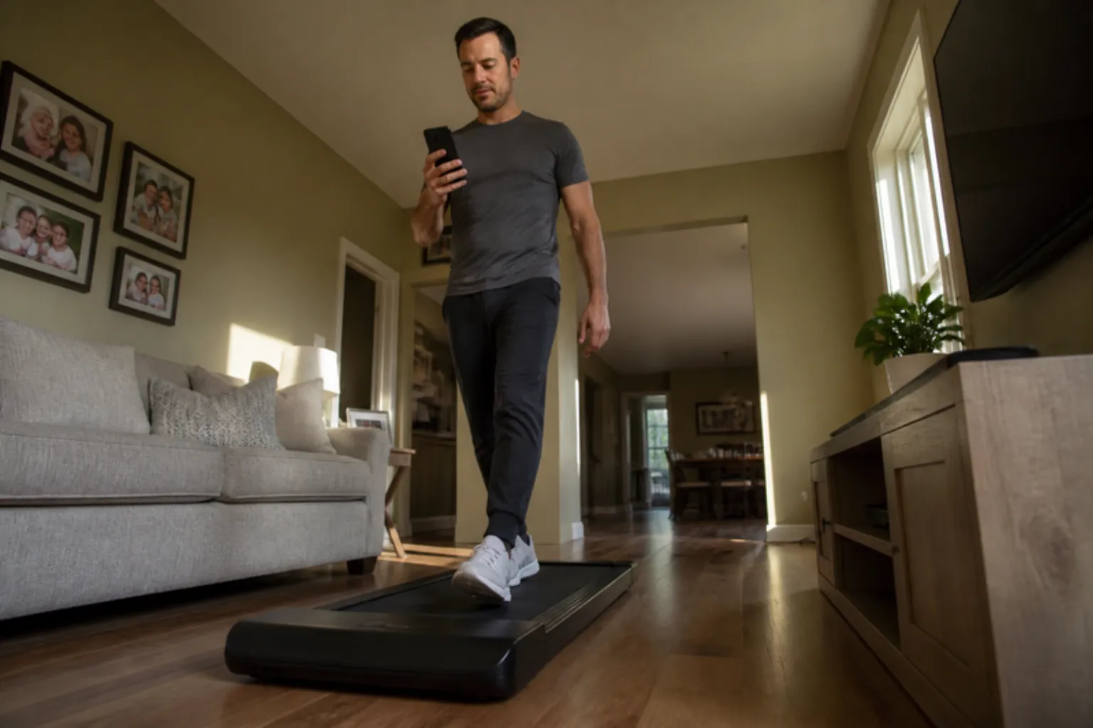 Man walking on a walking pad in his living room